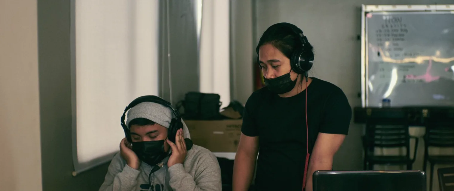 A consultant and a studio engineer going through a camera set-up together